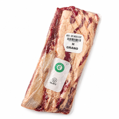 Packaged raw meat ribeye with labels on a white background